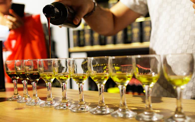 Olive oil being poured into tasting glasses during a Chianti experience.