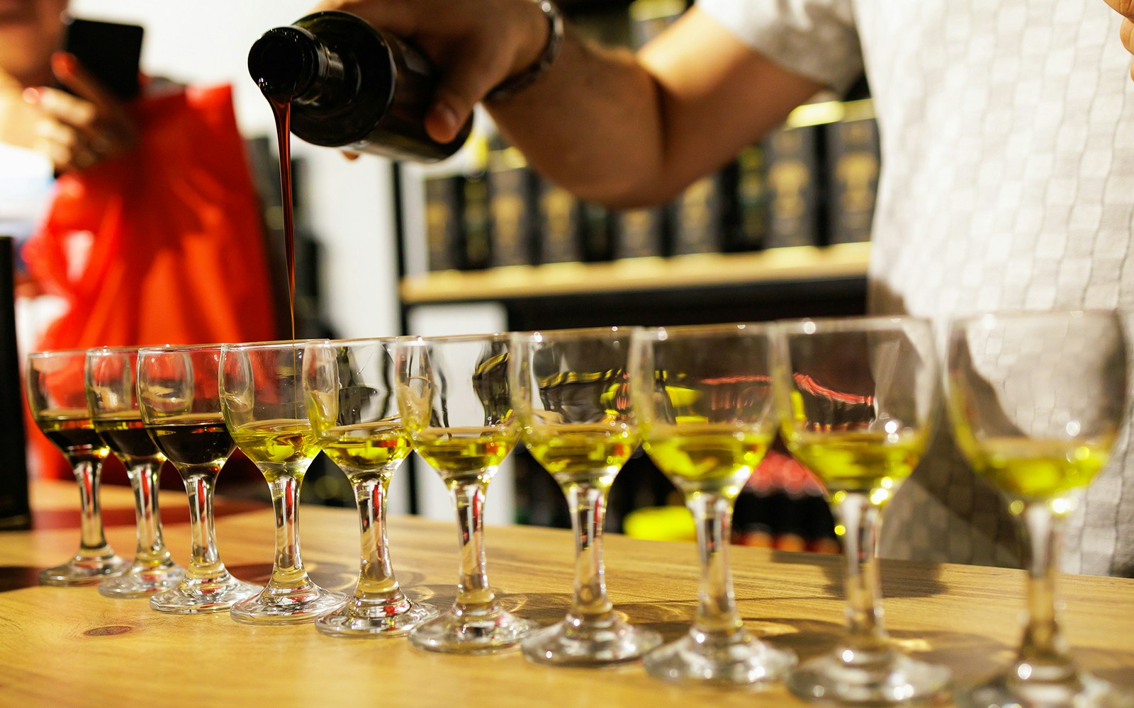 Olive oil being poured into tasting glasses during a Chianti experience.