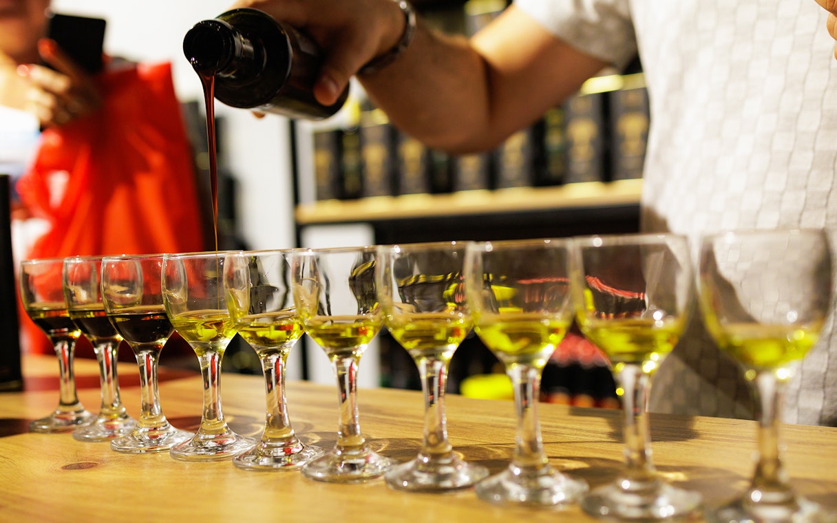 Olive oil being poured into tasting glasses during a Chianti experience.