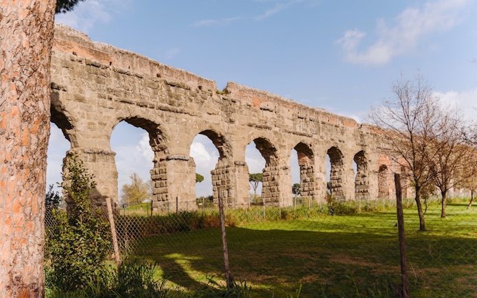 Ancient Roman aqueduct along the Appian Way in Rome, Italy.