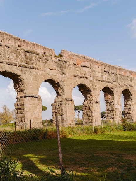Ancient Roman aqueduct along the Appian Way in Rome, Italy.