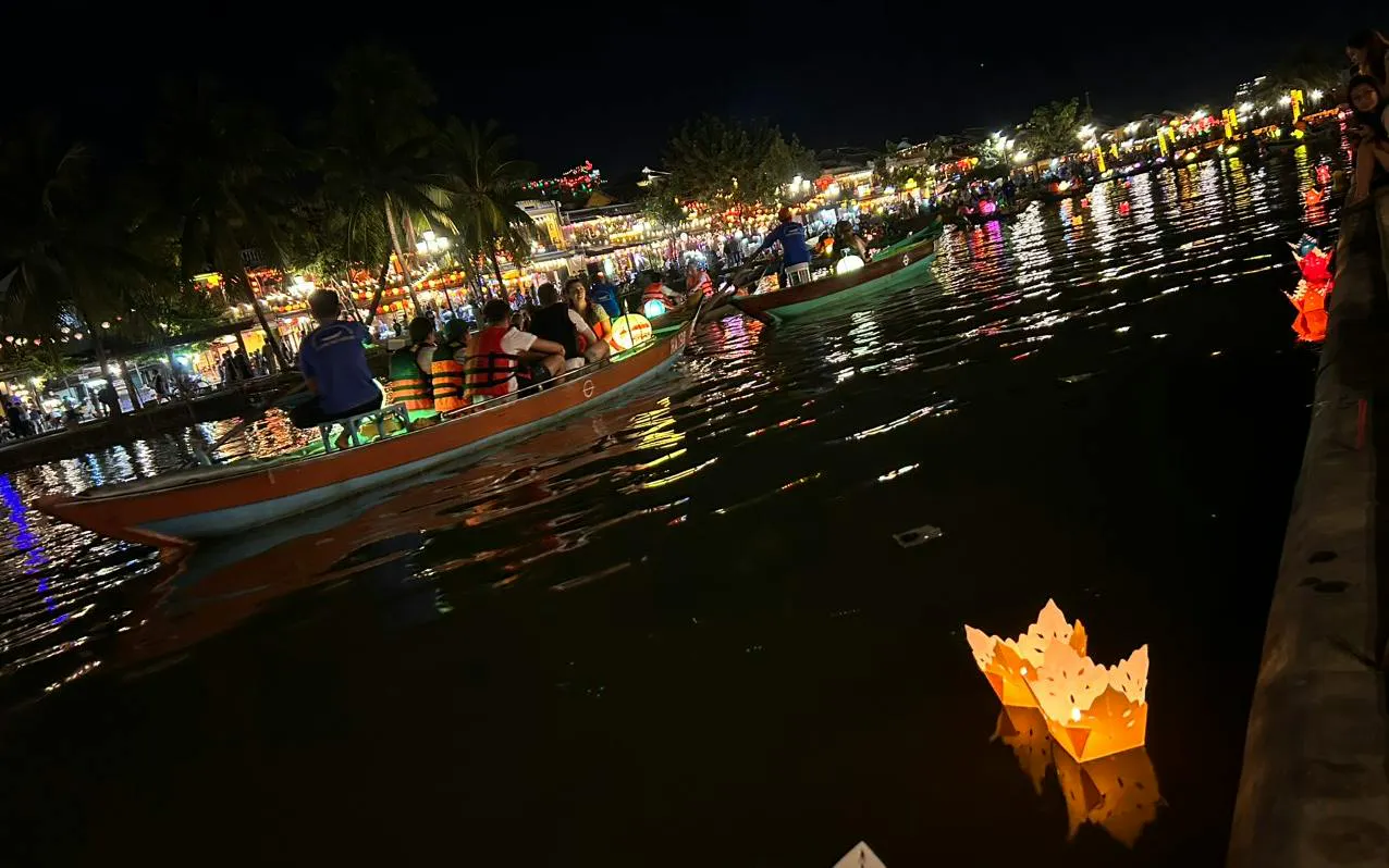 Boat ride with lanterns on water, offering free herbal drink in Dubai.