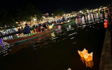 Boat ride with lanterns on water, offering free herbal drink in Dubai.