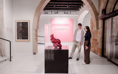 Visitors viewing modern art sculpture at Moco Museum Barcelona.