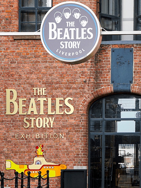 Beatles Story exhibition entrance in Liverpool with anniversary banners.