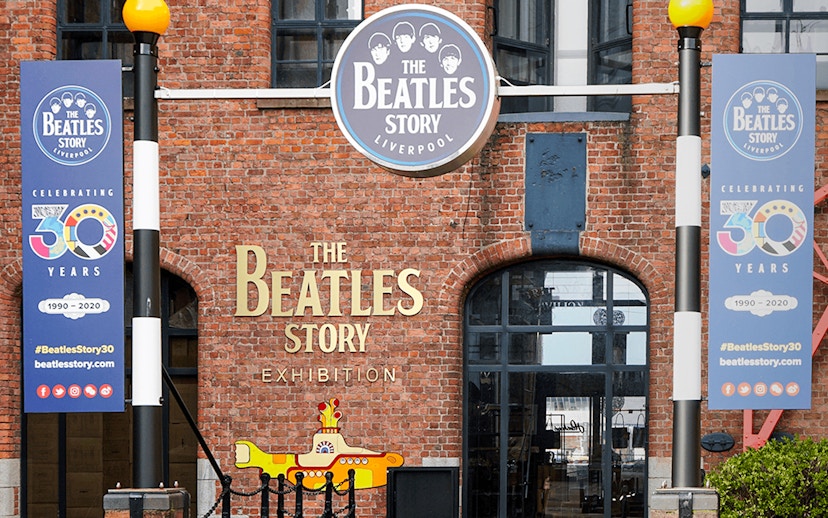 Beatles Story exhibition entrance in Liverpool with anniversary banners.
