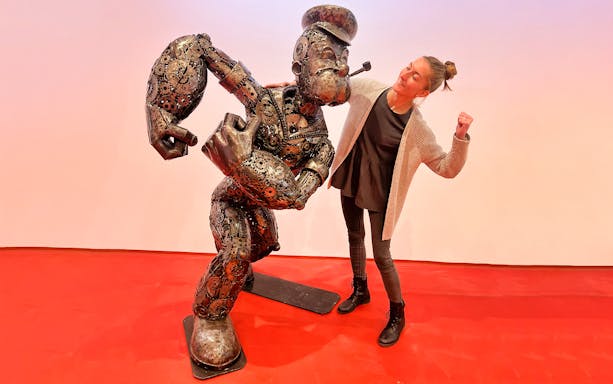 Steel figure of a cartoon character with a visitor at Gallery of Steel Figures, Prague.