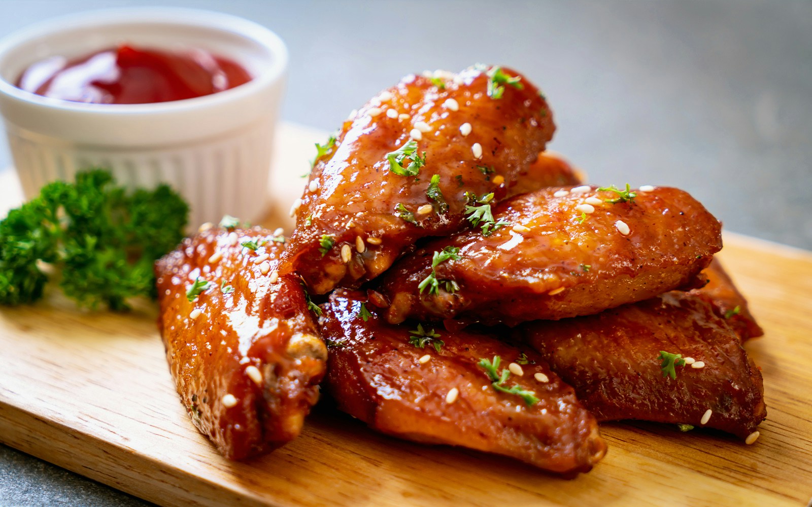 Chicken wings with fries and sauce on a plate, popular dish in New York City food tours.