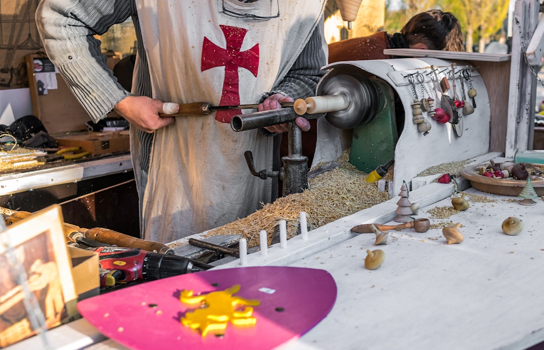 Vic Medieval Market stalls with visitors in Barcelona, showcasing local crafts and produce.