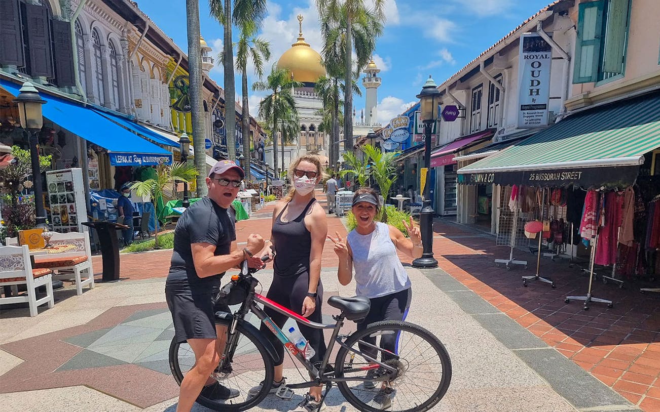 Tourists on a bike tour near Sultan Mosque in Singapore's Kampong Glam district.
