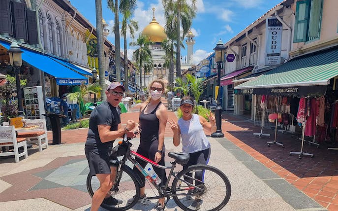 Tourists on a bike tour near Sultan Mosque in Singapore's Kampong Glam district.