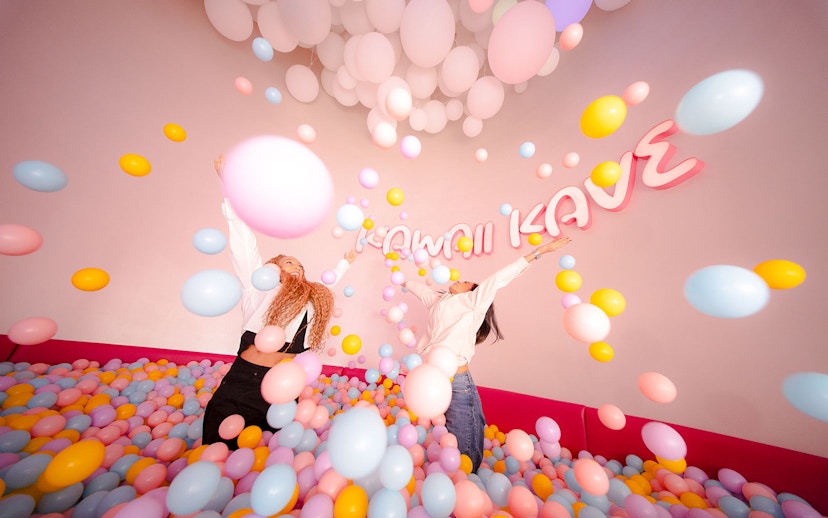 Tourists enjoying colorful ball pit at House of Hype, Dubai.