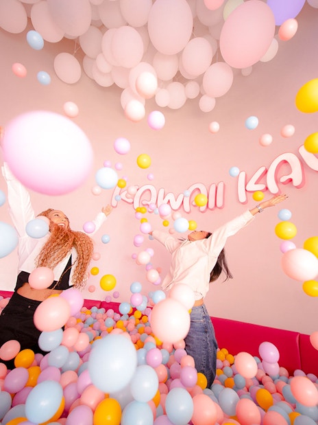 Tourists enjoying colorful ball pit at House of Hype, Dubai.
