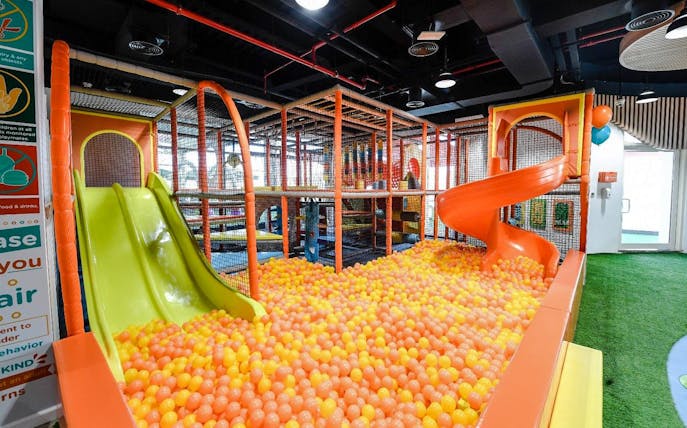 Soft play area with slides and ball pit at Orange Wheels, Global Village, Dubai.
