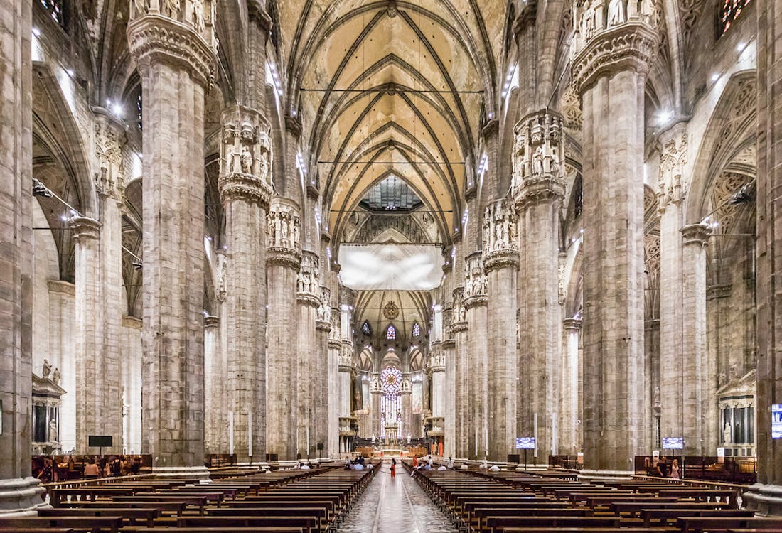 Duomo Milan Cathedral facade with tourists on Fast-Track guided tour, Italy.