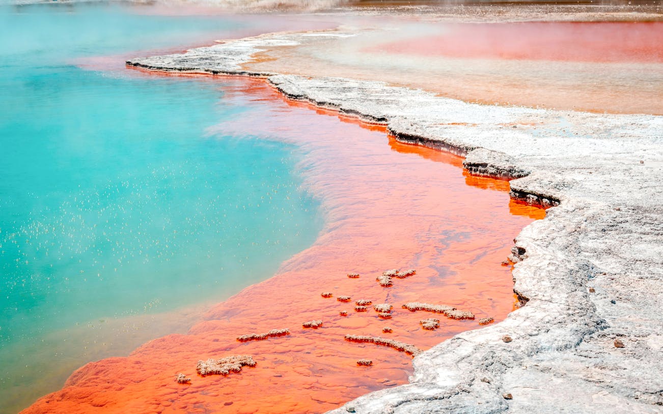Geothermal pool with vibrant orange and turquoise colors at Wai-O-Tapu Thermal Wonderland.