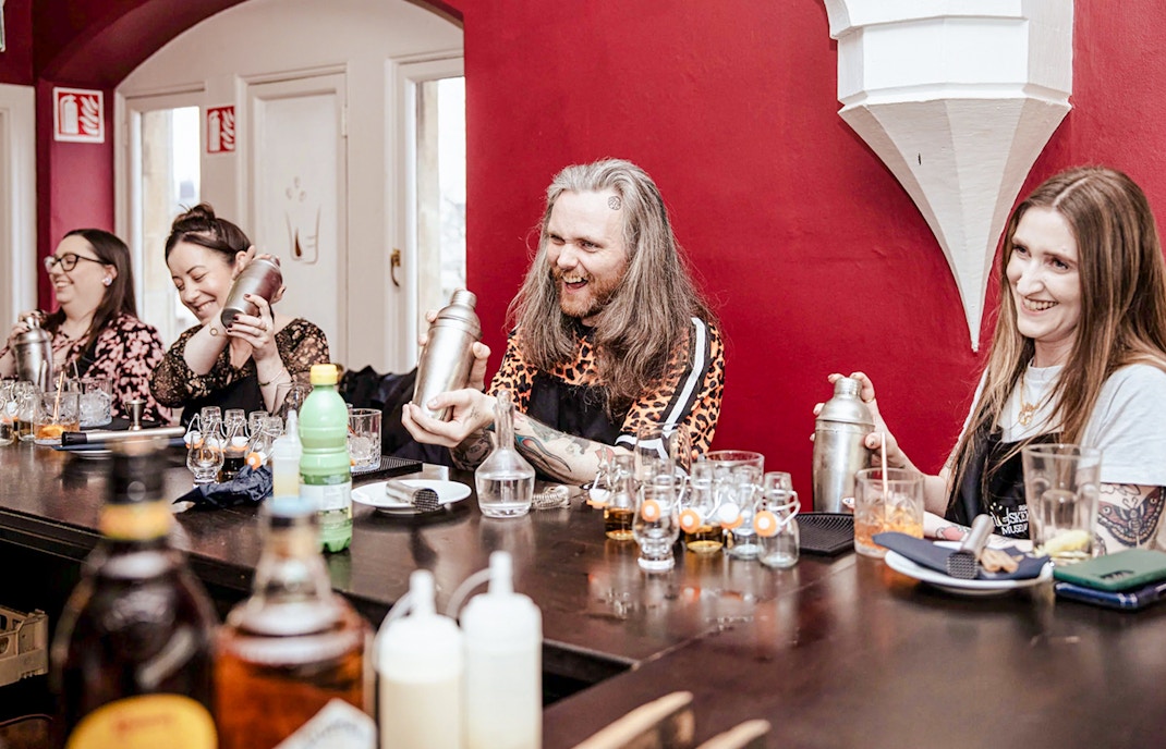 Guests learning to mix drinks at Cocktail Masterclass, Irish Whiskey Museum, Dublin.