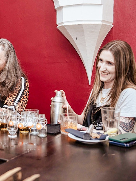 Participants shaking cocktail shakers at the Irish Whiskey Museum masterclass.