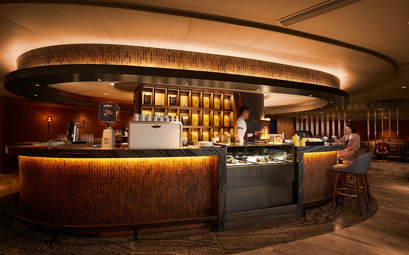 First-class lounge bar at Hong Kong International Airport with seating and refreshments.