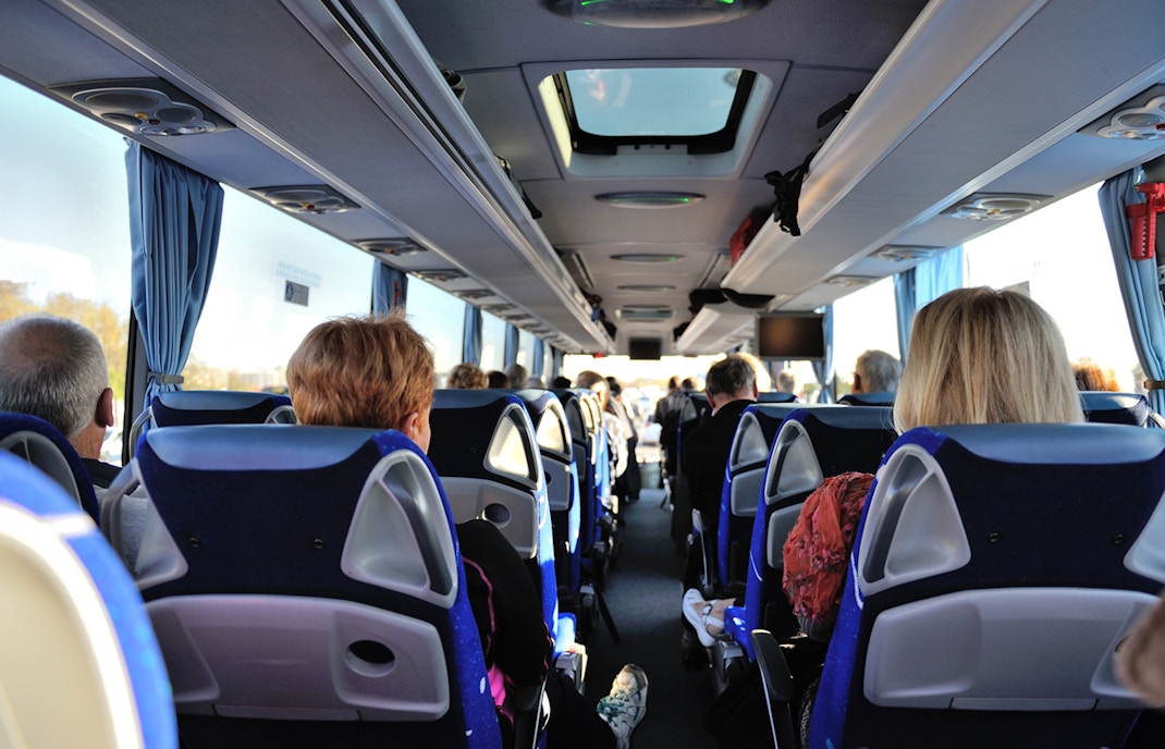 Tourists seated inside a bus touring Washington D.C. monuments.