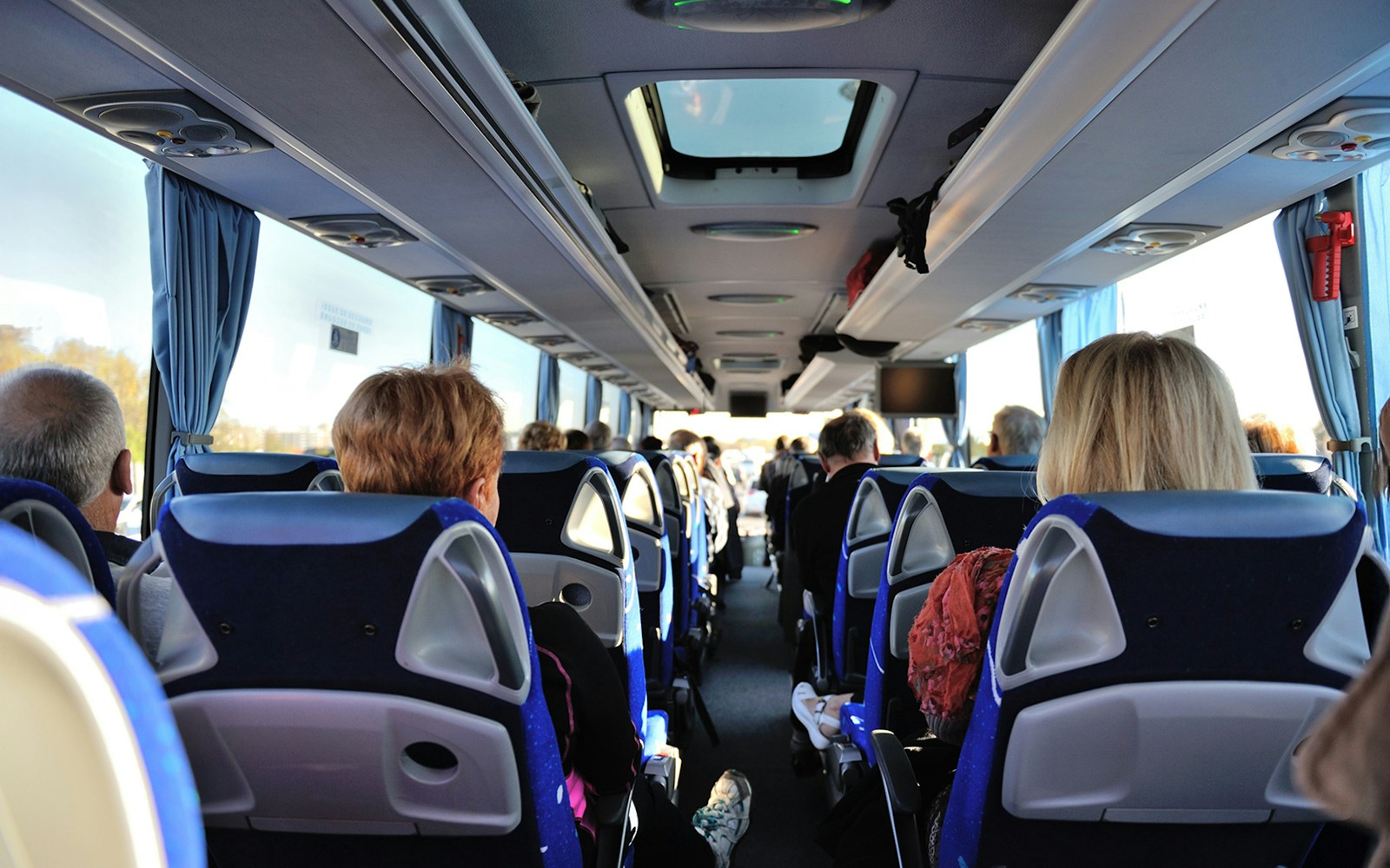 Tourists seated inside a bus touring Washington D.C. monuments.