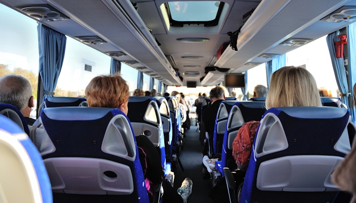 Tourists seated inside a bus touring Washington D.C. monuments.
