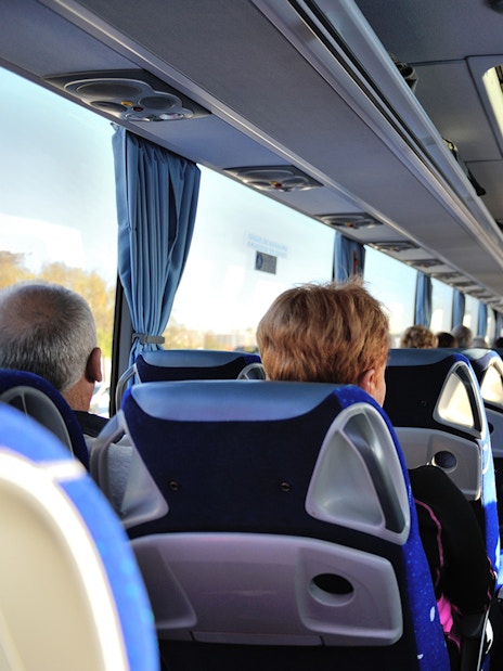 Tourists seated inside a bus touring Washington D.C. monuments.