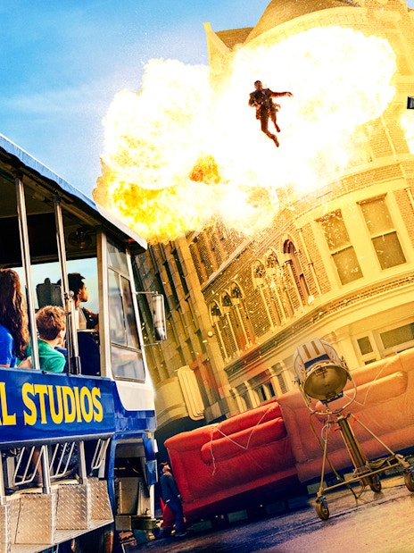 Universal Studios Hollywood tram tour with guests watching a movie stunt explosion scene.