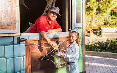 Child receiving candy at Brick or Treat Street, Legoland Florida.