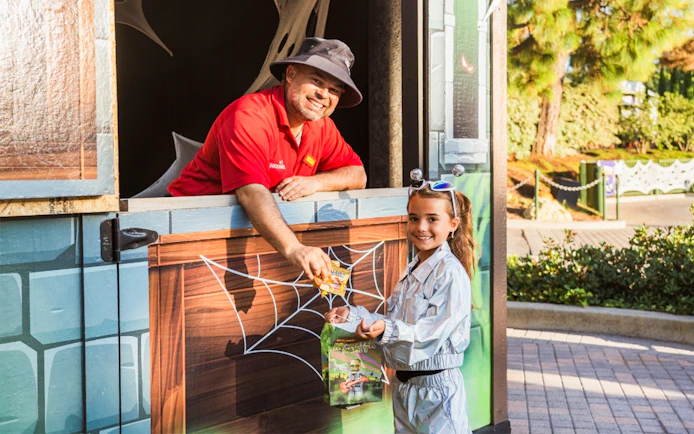 Child receiving candy at Brick or Treat Street, Legoland Florida.