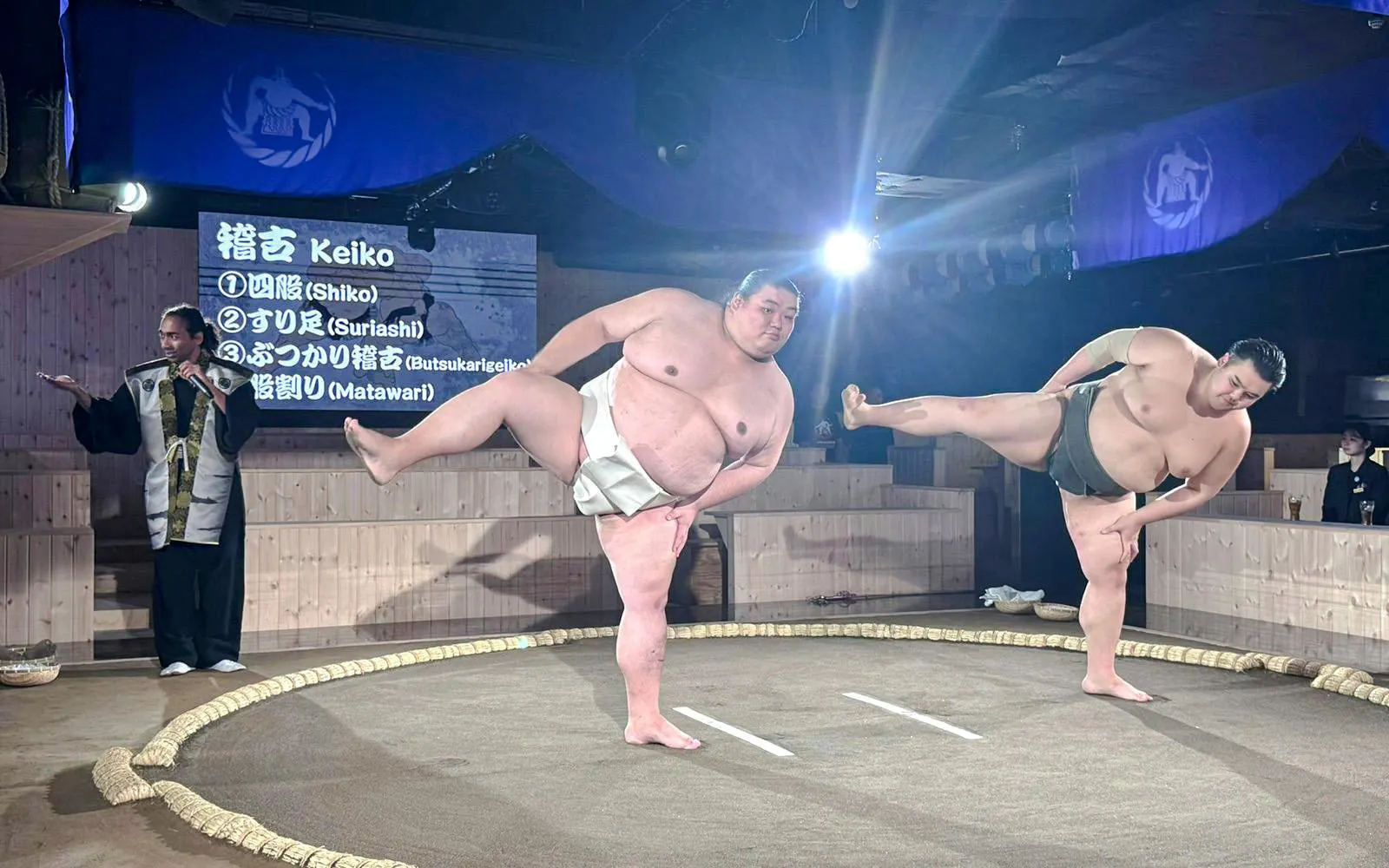 Sumo wrestlers warming up at Authentic Sumo Experience in Tokyo.