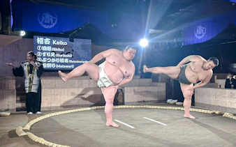 Sumo wrestlers warming up at Authentic Sumo Experience in Tokyo.