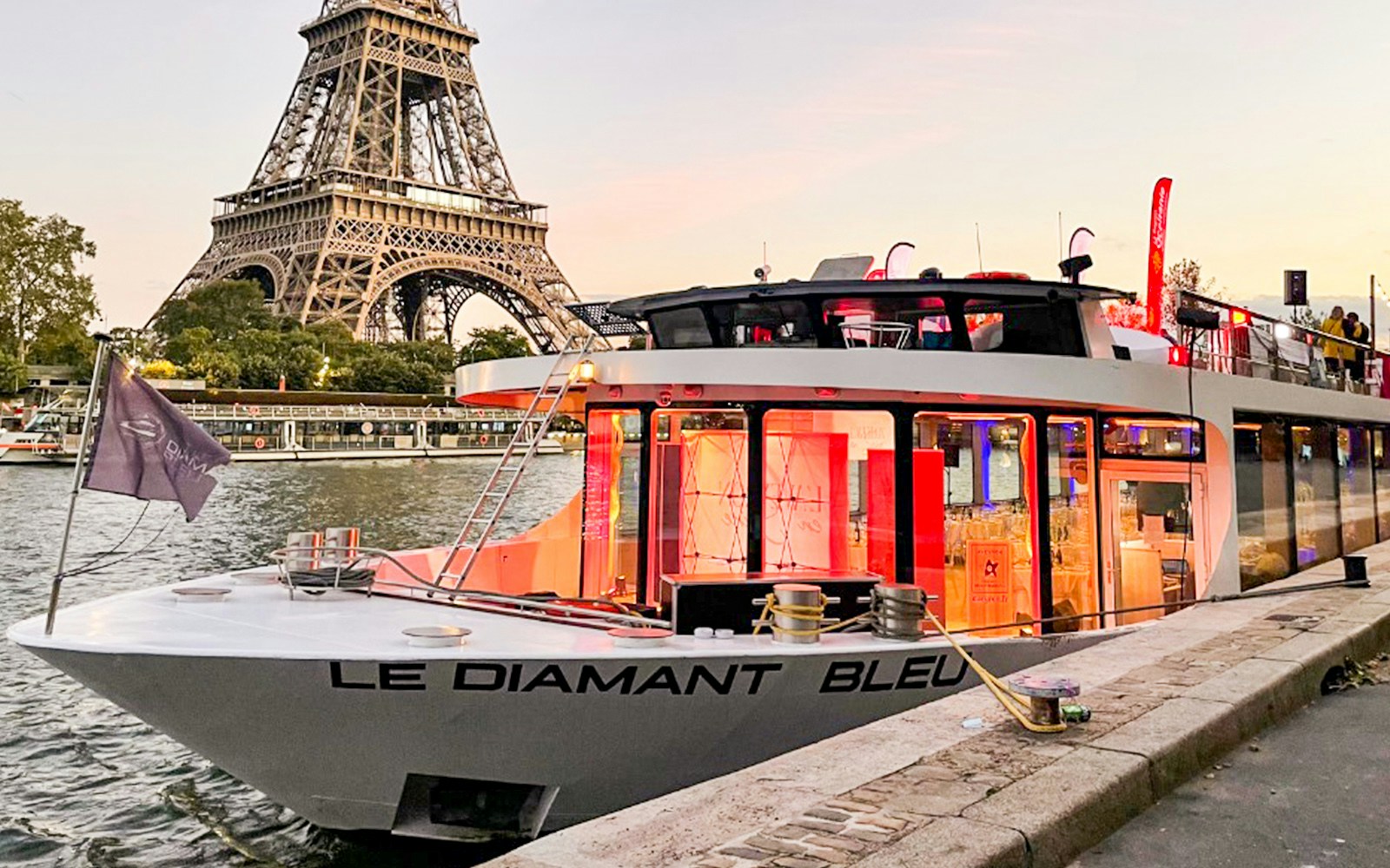 Seine River dinner cruise on Le Diamant Bleu with French premium menu, Paris landmarks in view.