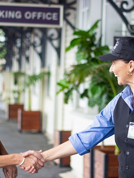 Mary Valley Rattler staff greeting a passenger at the booking office.