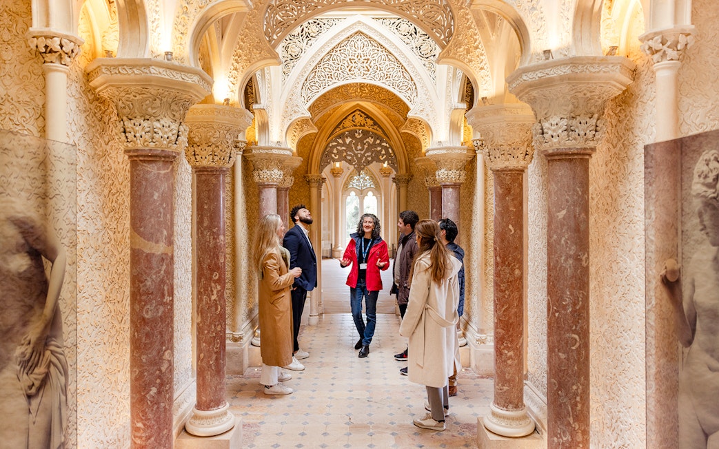 Tour group exploring ornate hallway in Monserrate Palace, Sintra.