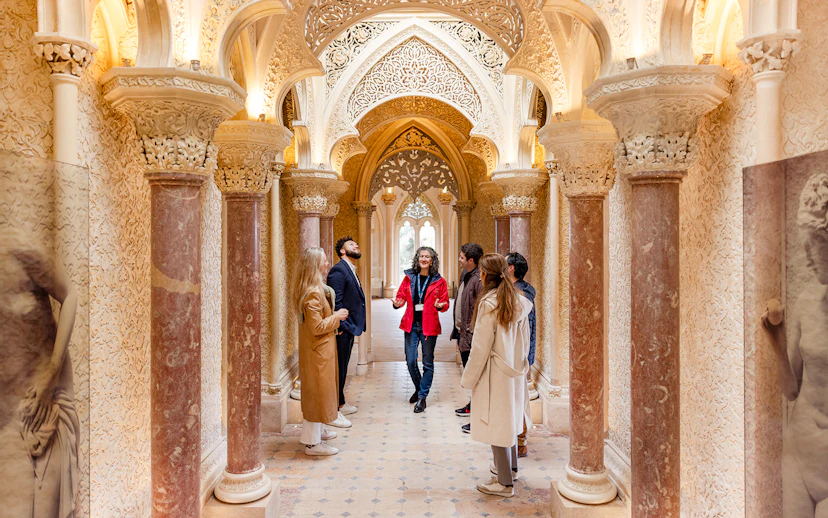Tour group exploring ornate hallway in Monserrate Palace, Sintra.