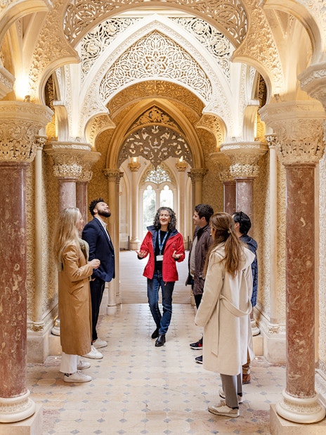 Tour group exploring ornate hallway in Monserrate Palace, Sintra.