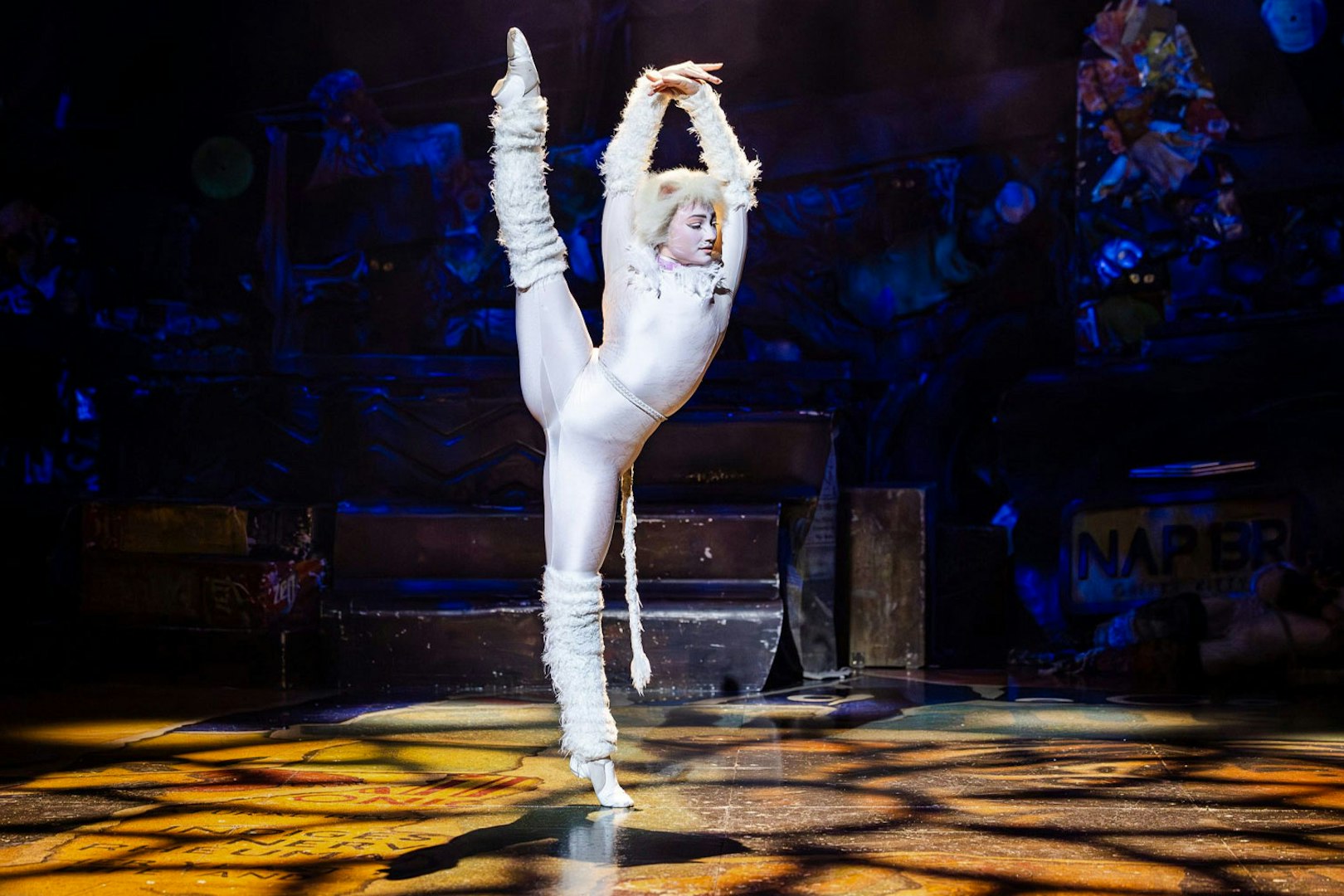 Performer in white costume on stage at Cats show, Perth.
