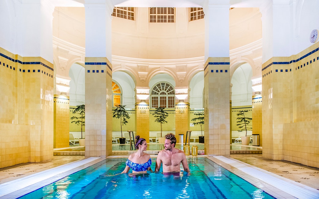 Guests relaxing in indoor pool at Premium Day Spa, Szechenyi Bath, Budapest.