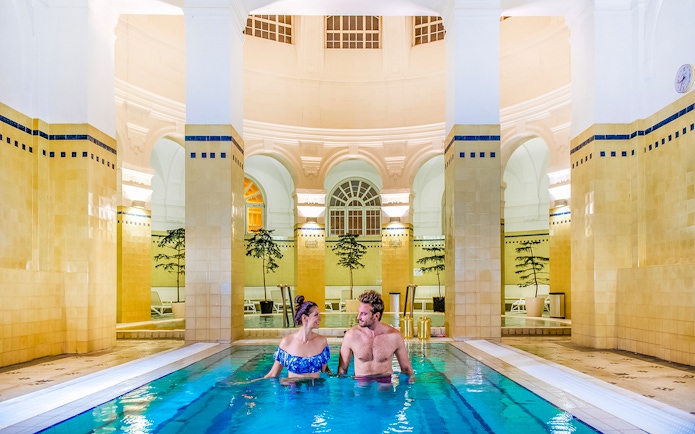 Guests relaxing in indoor pool at Premium Day Spa, Szechenyi Bath, Budapest.