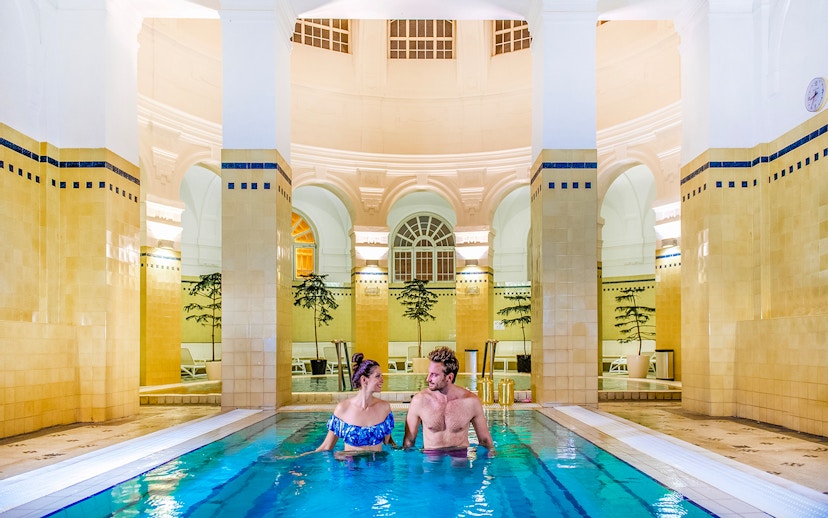 Guests relaxing in indoor pool at Premium Day Spa, Szechenyi Bath, Budapest.