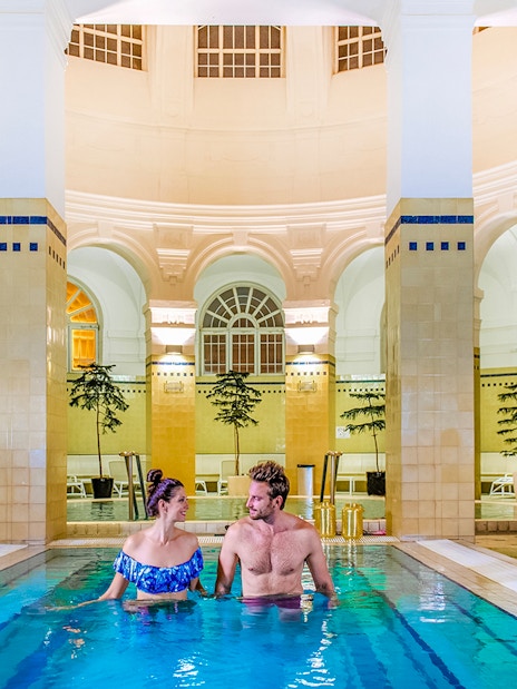 Guests relaxing in indoor pool at Premium Day Spa, Szechenyi Bath, Budapest.