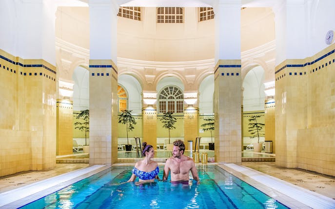 Guests relaxing in indoor pool at Premium Day Spa, Szechenyi Bath, Budapest.