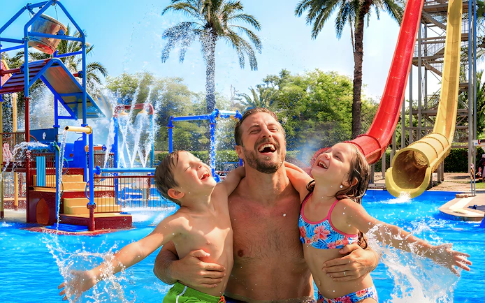 Family enjoying water play area at Aquopolis Torrevieja mini park.
