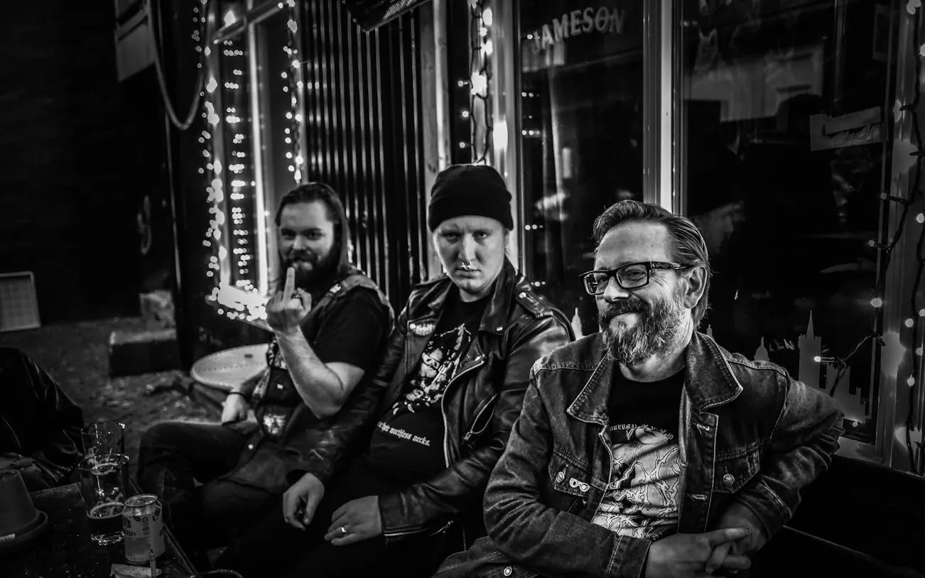 Three people sitting outside a Reykjavík bar, part of the Icelandic Punk History Tour.