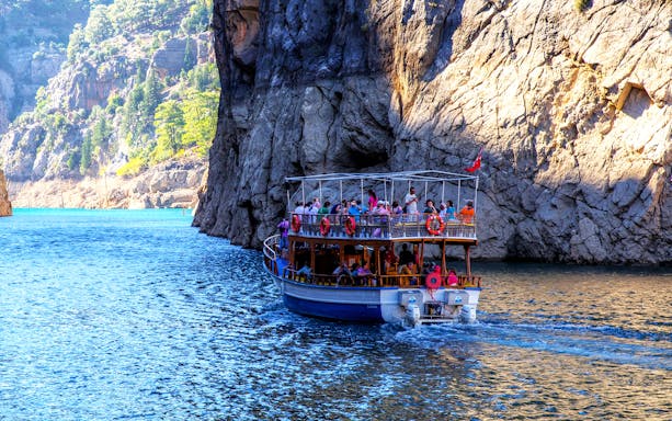 Boat tour navigating through Green Canyon cliffs near Antalya.