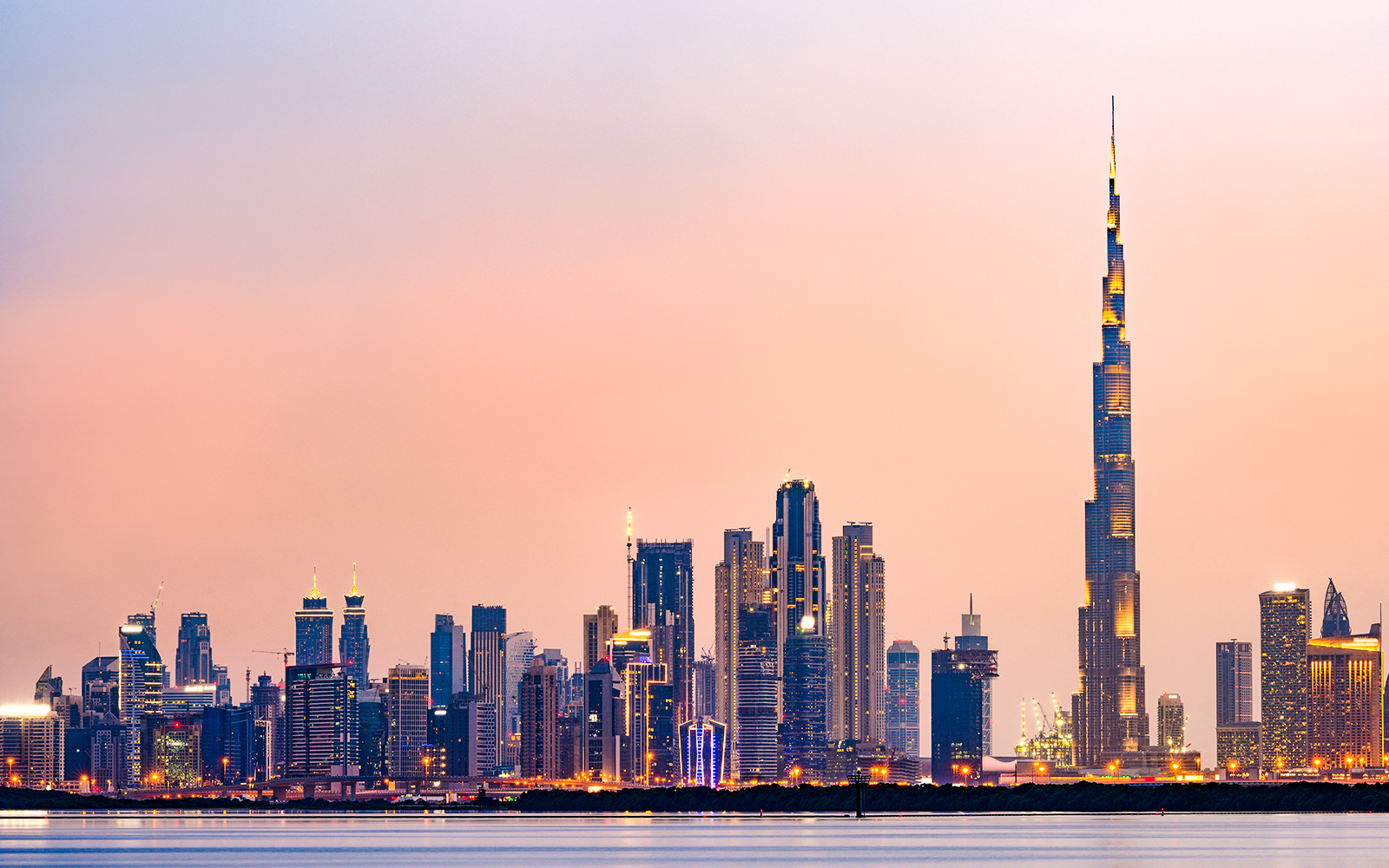 Dubai skyline with Burj Khalifa at sunset.