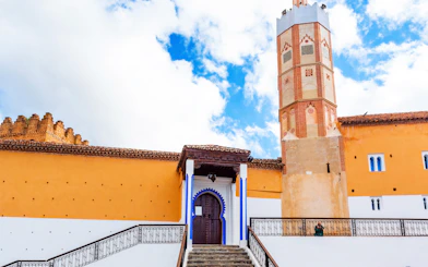 El Masjid El Aadam Grand Mosque entrance and minaret in Chefchaouen, Morocco.
