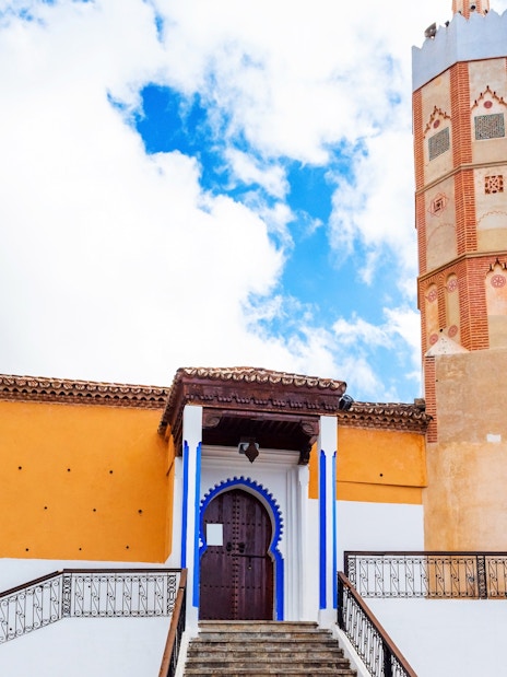 El Masjid El Aadam Grand Mosque entrance and minaret in Chefchaouen, Morocco.