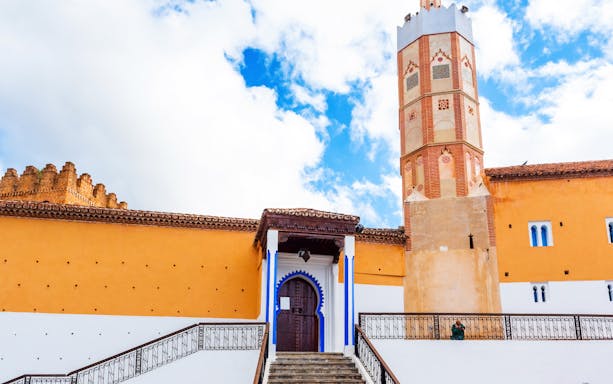 El Masjid El Aadam Grand Mosque entrance and minaret in Chefchaouen, Morocco.